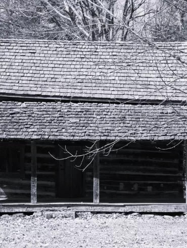 Old man in old cabin by Edgar A. Porter